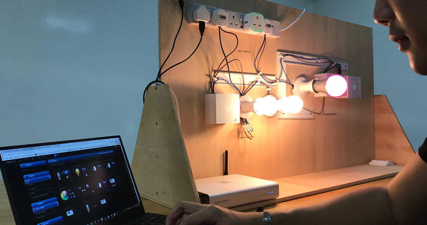 Photo of person setting up smart lights with a notebook computer