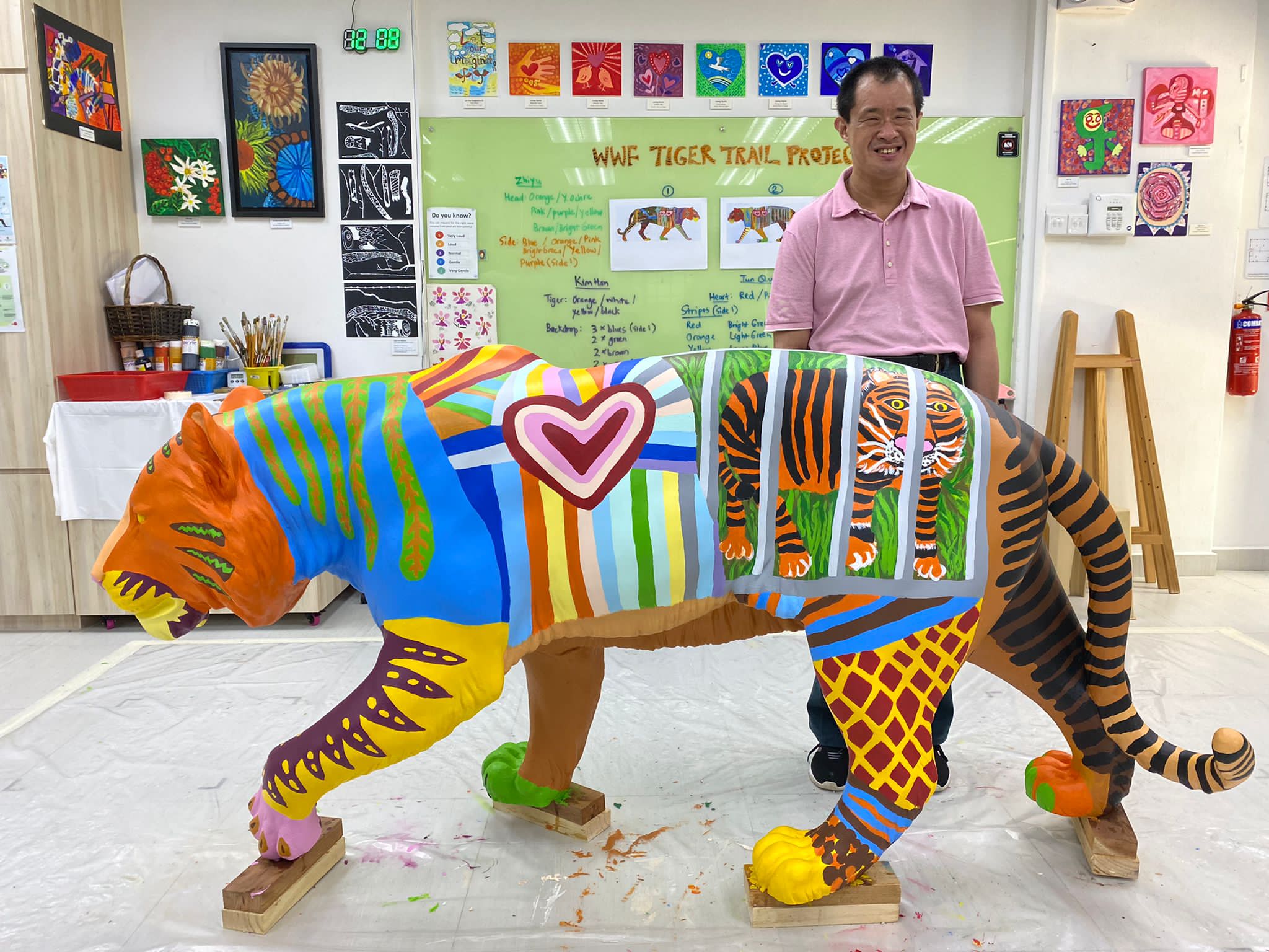 JOURNEY by TOUCH Community Services artist posting with their completed Tiger sculpture 