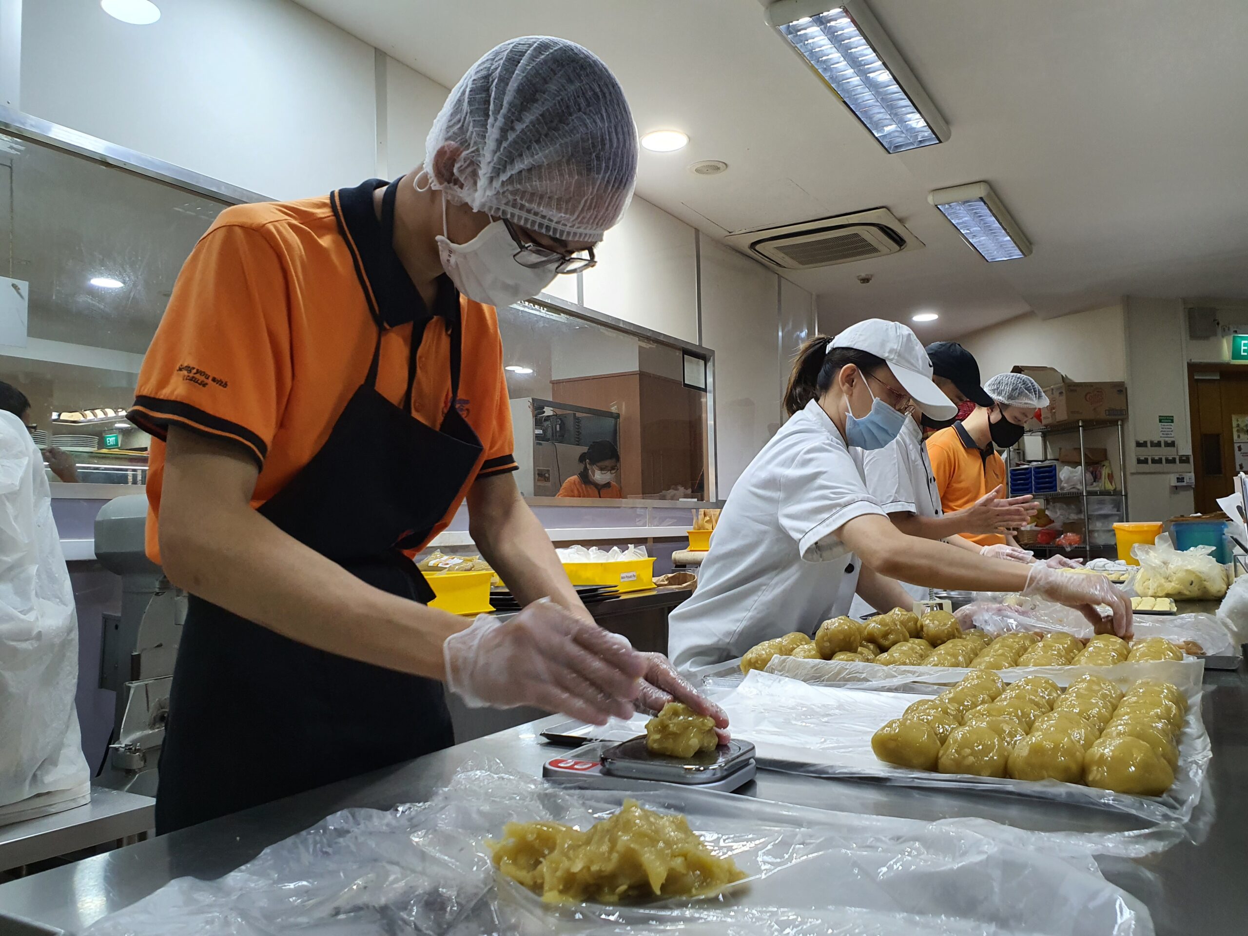 Cher Wei Jie weighing the exact portions for the mooncake.