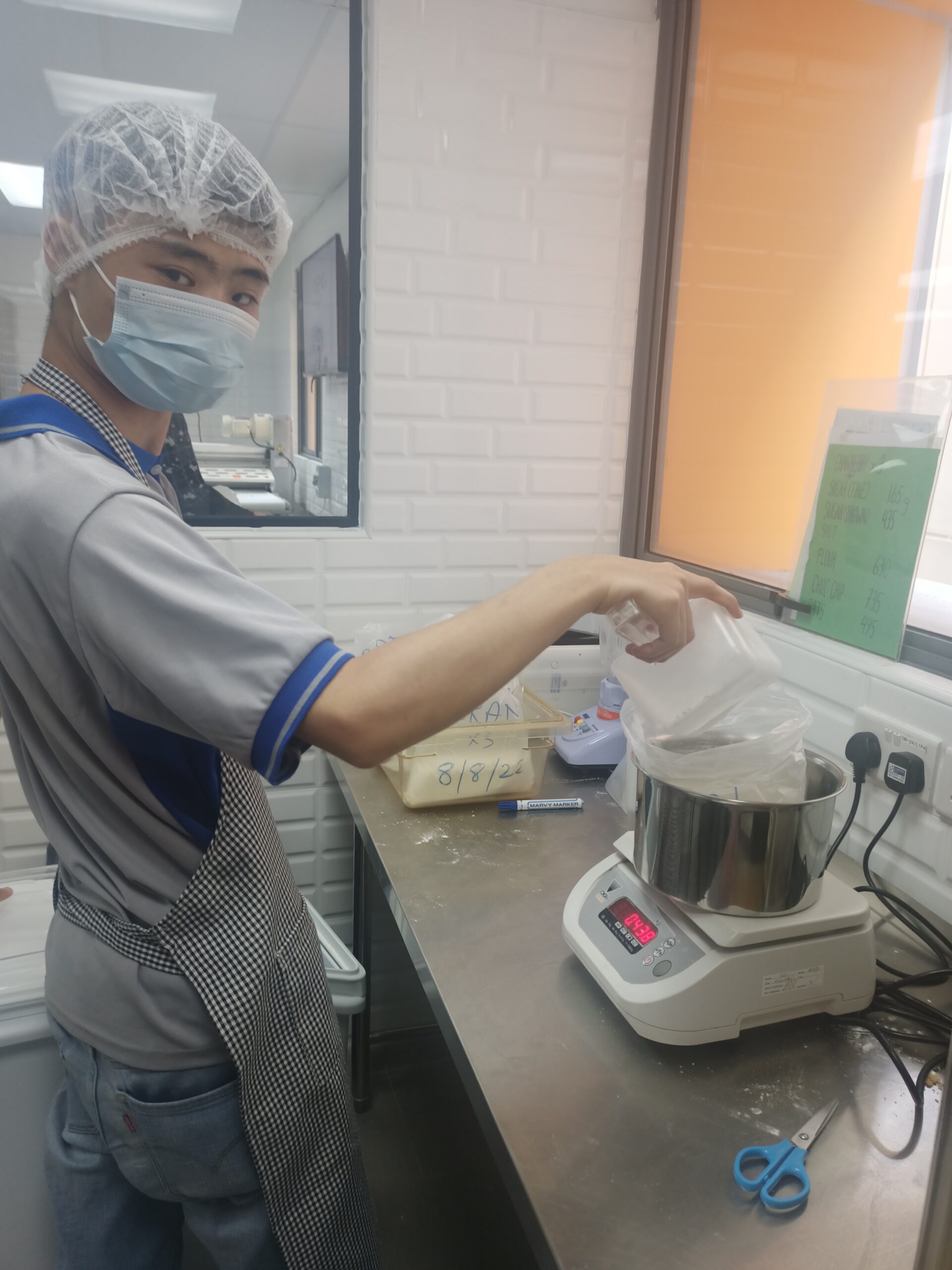Esmond posing with weighing scale for baking