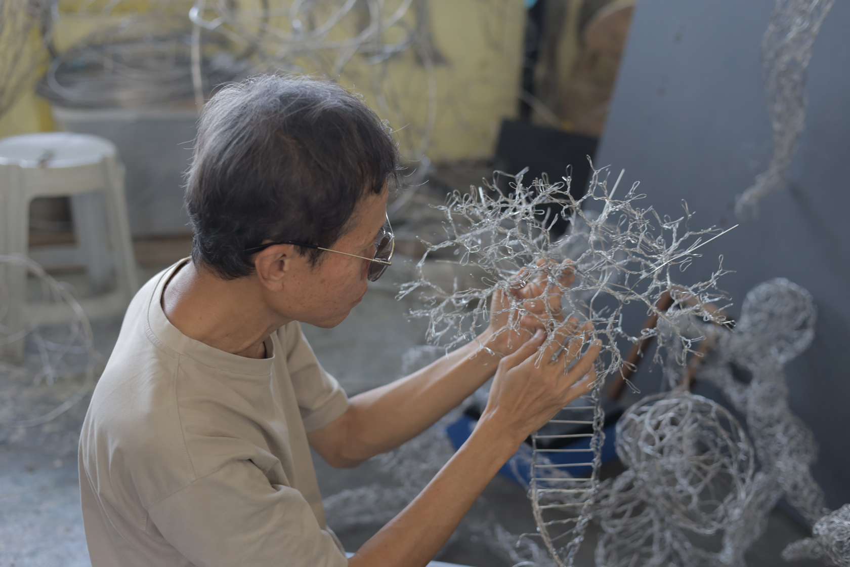 A candid photo of victor tan working on his sculpture