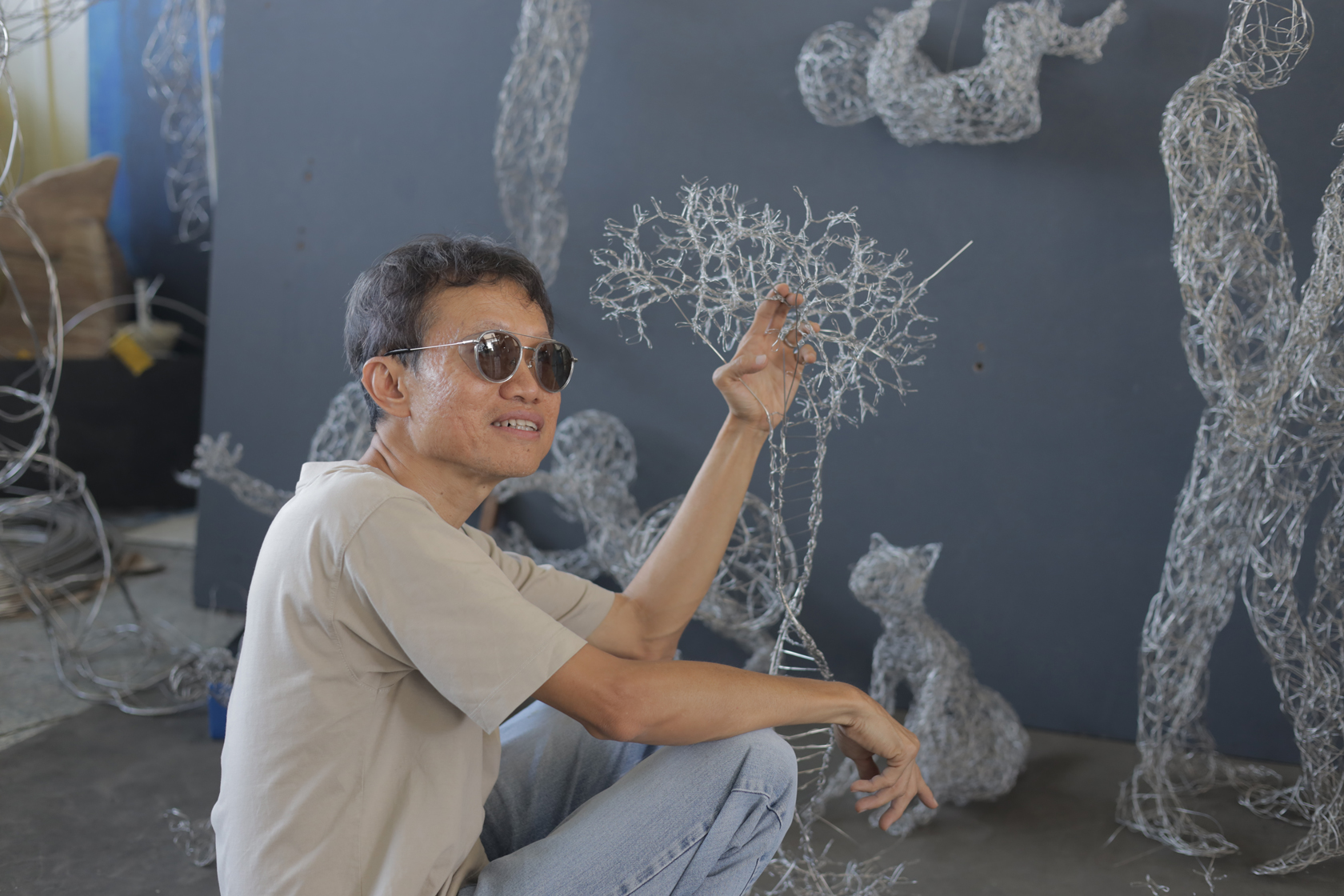 A photo of Victor Tan wearing sunglasses in his workshop posing for the camera